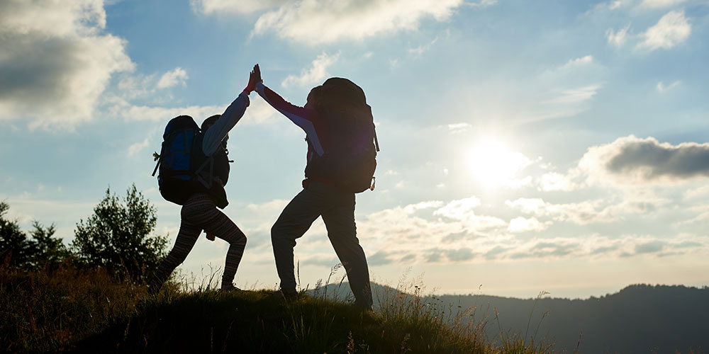 2 hikers high-fiving